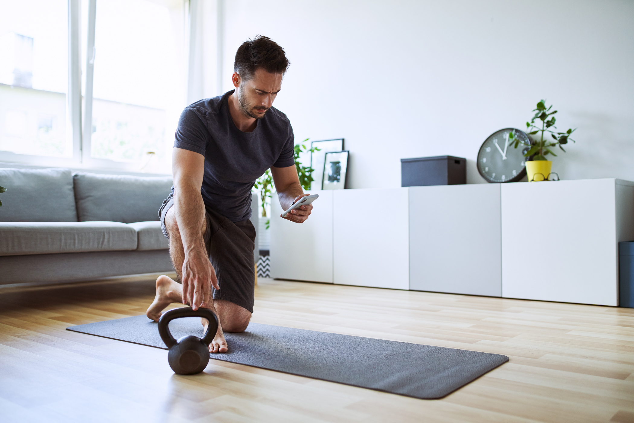 Man setting up online workout app at home